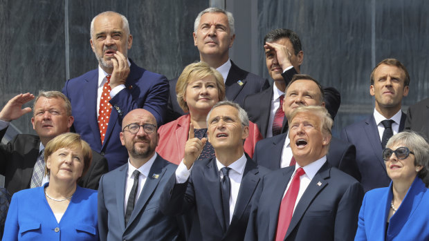 From the left, German Chancellor Angela Merkel, Belgian PM Charles Michel, NATO Secretary-General Jens Stoltenberg, US President Donald Trump and British PM Theresa May pose with other leaders for a family picture at NATO in Brussels.