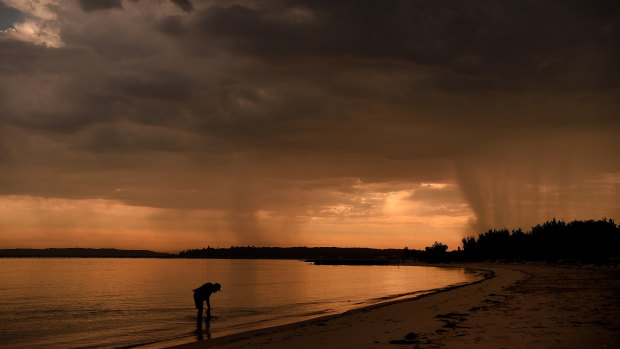 Dark clouds loom over Sydney's Botany Bay on Wednesday morning: fire risks are likely to be elevated across south-eastern Australia well into the weekend as another heatwave sweeps in.