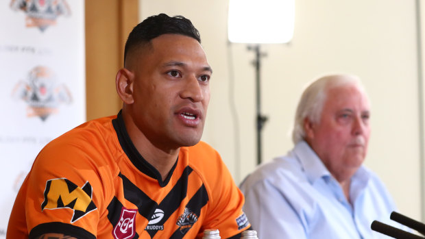 Israel Folau, pictured with backer Clive Palmer, said on Friday he was excited to return to the “grassroots level”.