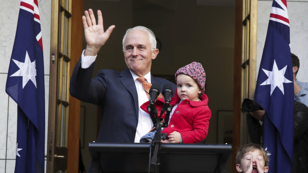 Malcolm Turnbull waves goodbye at the end of his final press conference as prime minister, with granddaughter Alice and grandson Jack. 