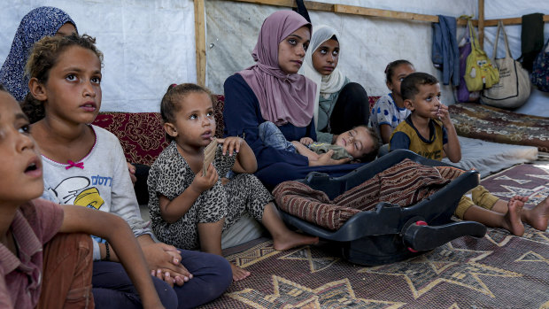 Displaced infant Abdel-Rahman Abu el-Jedian, now 11 months old, who suffers from polio, is cradled by his mother, at a makeshift camp in Deir al-Balah, central Gaza Strip on Tuesday.