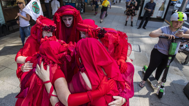Activists from Extinction Rebellion participate in a "funeral procession" in Brisbane on Tuesday.