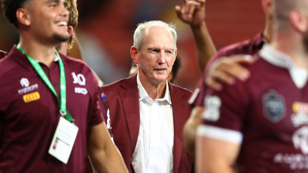 A contented Wayne Bennett looks on as the Maroons celebrate a famous victory.
