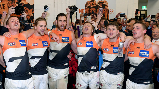 GWS Giants players belt out the team song after their preliminary final win over Collingwood with President Tony Shepherd, back right.