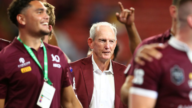 A contented Wayne Bennett looks on as the Maroons celebrate a famous victory in 2020.