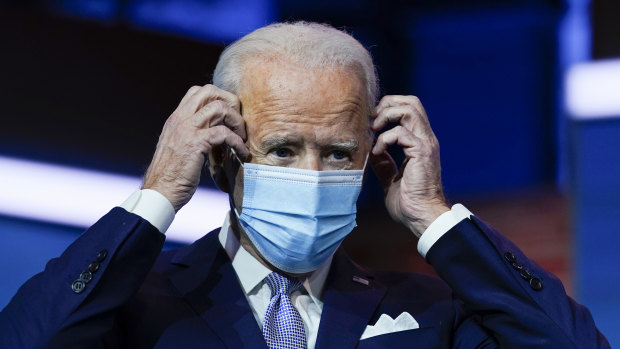 President-elect Joe Biden puts on his face mask after a press conference on Tuesday.