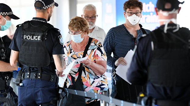 Police screen incoming passengers at the domestic airport in Brisbane on April 3.