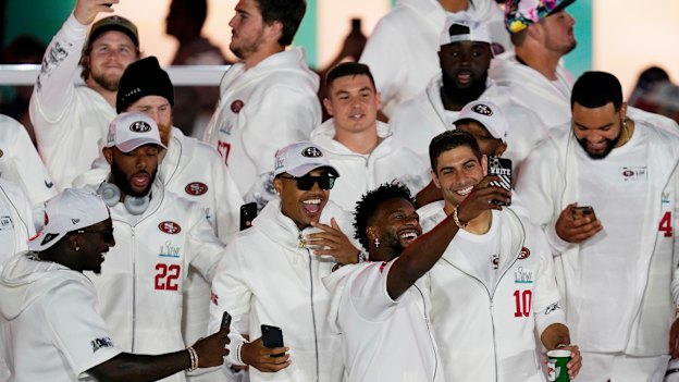 San Francisco 49ers take selfies after arriving in Miami ahead of the Super Bowl.