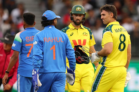 Mitchell Marsh of Australia talks with KL Rahul of India. 