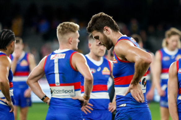 Marcus Bontempelli and Adam Treloar look dejected after the Bulldogs’ shock loss to the Hawks.