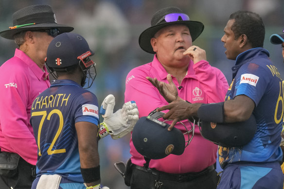 Sri Lanka’s Angelo Mathews, right, talks to umpires after he was declared timed out during the World Cup match between Bangladesh and Sri Lanka.