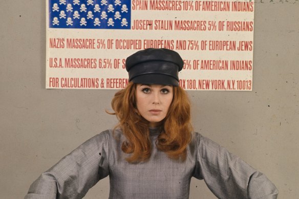 Lumley with an anti-war poster in the form of the American flag during her Avengers days.