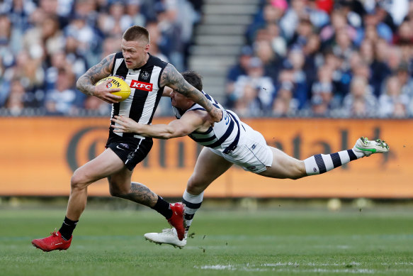 Jordan De Goey, who starred for the Magpies, is tackled by Patrick Dangerfield.