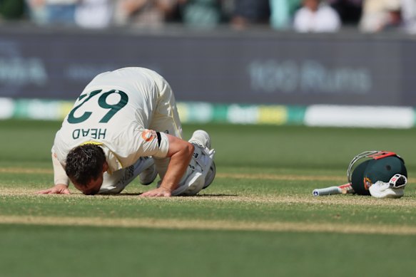 Travis Head kisses the Adelaide Oval pitch after reaching triple figures. 