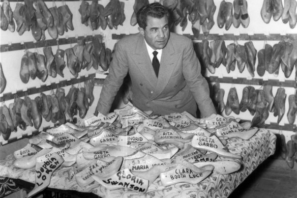 Italian designer Salvatore Ferragamo with some of his shoe shapes.