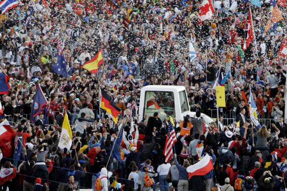 Pope Benedict XVI waves from his popemobile at World Youth Day in Sydney in 2008.
