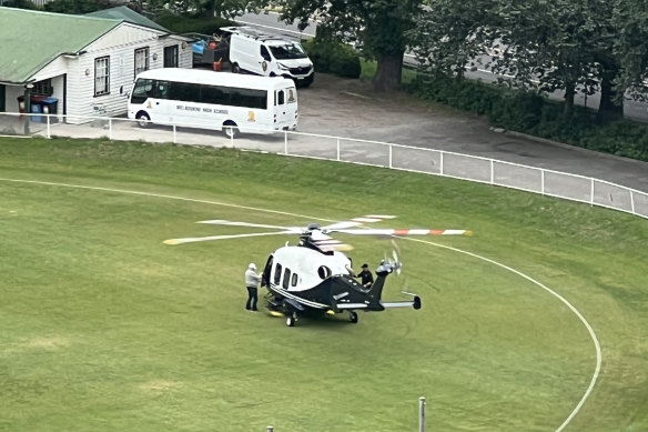 Lindsay Fox alighting from his helicopter on Melbourne High School’s oval.