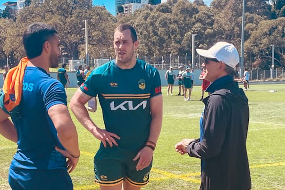 Wallaby Tom Wright (left), Isaah Yeo (centre) and Les Kiss chat after the Kangaroos trained on Monday.