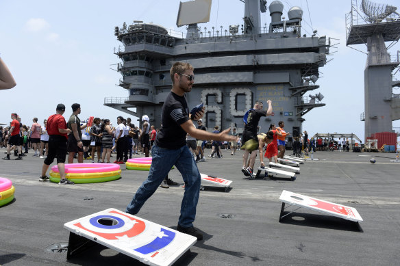 Sailors participate in sporting events on the flight deck of the USS Dwight D. Eisenhower. 