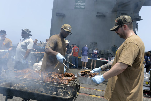 Sailors participate in a steel beach picnic on the flight deck of the aircraft carrier USS Dwight D. Eisenhower.