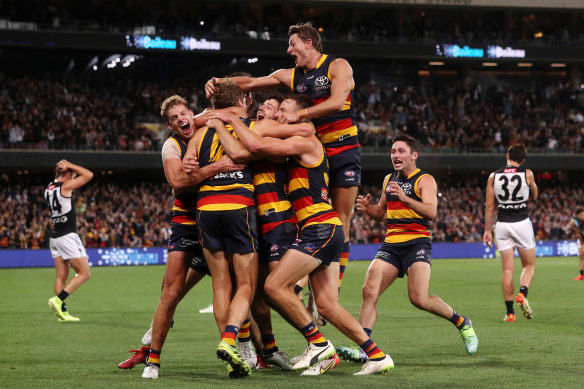The Adelaide Crows celebrate their win over the siren.