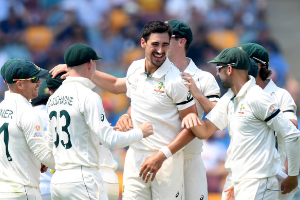 Mitchell Starc celebrates taking the wicket of Haris Sohail on day one of the first Test at the Gabba.
