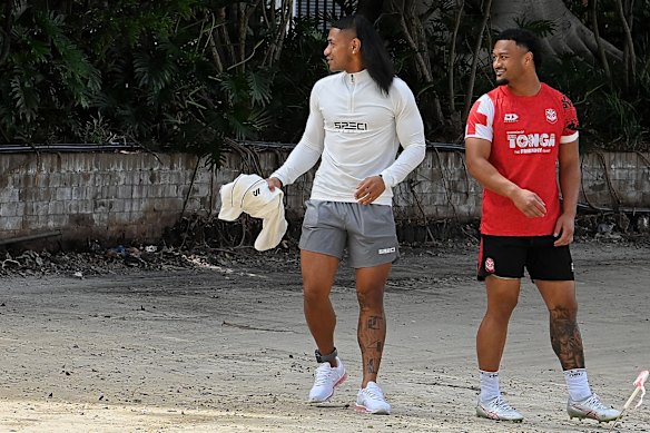 Former NRL player Manase Fainu (left) wearing an ankle bracelet on day release from prison at Tonga’s national rugby league team training session at Wentworth Park earlier this week.