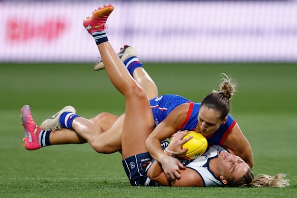Physical clash: Geelong’s Rebecca Webster is tackled by Dominique Carruthers of the Bulldogs.
