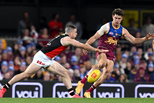 Jarrod Berry of the Lions gets a kick away.