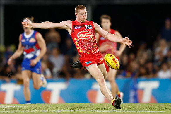 Matt Rowell of the Suns kicks the ball. 