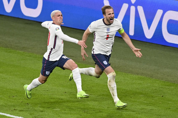 Phil Foden (left) and Harry Kane celebrate the latter’s decisive goal at Wembley.