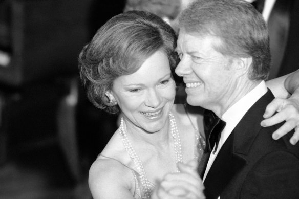 President Jimmy Carter and his wife Rosalynn lead their guests in dancing at the annual Congressional Christmas Ball at the White House in 1978.