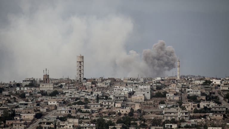 Smoke rises after a bomb hit  a rebel position during heavy fighting in the Idlib province, Syria. 