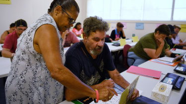 Literacy for Life facilitator Judy McGuinness talking to student Charles Booth, 63, at his first literacy class in Airds.