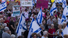 Protesters hold signs and flags during a demonstration calling for a hostages deal and against Israeli Prime Minister Benjamin Netanyahu and his government.