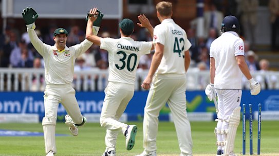 Alex Carey and Pat Cummins celebrate Jonny Bairstow’s wicket.