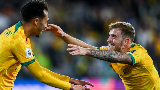 Australia’s Nishan Velupillay celebrates after scoring with Riley McGree in the Socceroos’ 3-1 win over China on Thursday.
