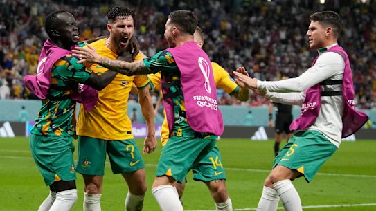 Australia’s Mathew Leckie, left, celebrates with his teammates after scoring his side’s goal during the World Cup group D match against Denmark.
