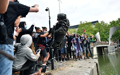 Protesters throw a statue of slave trader Edward Colston into the Bristol harbour this week.