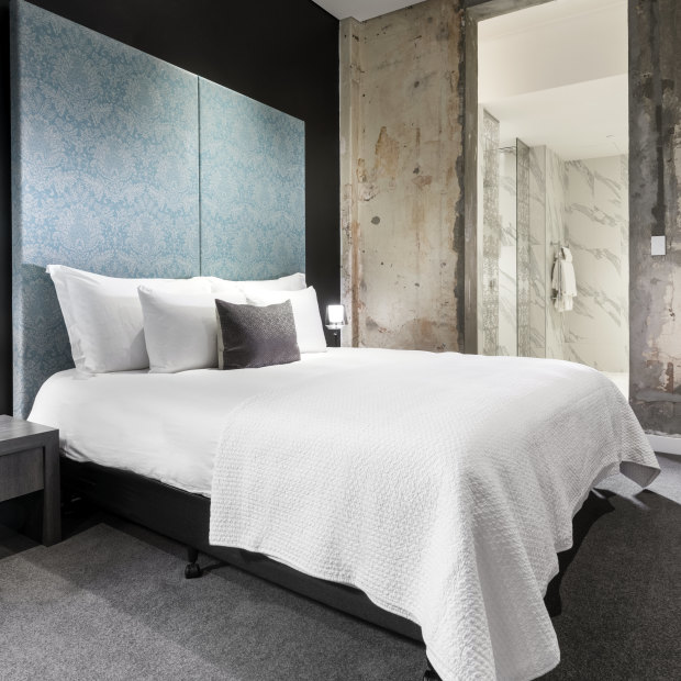 Dramatic, stripped-back concrete walls in The Melbourne Hotel’s original building.