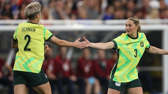 Michelle Heyman celebrates with Winonah Heatley after scoring a goal against the US.