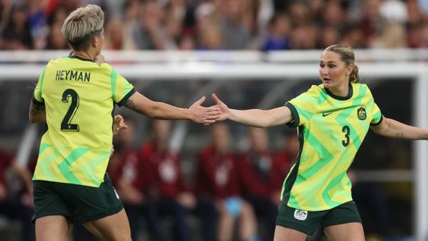Michelle Heyman celebrates with Winonah Heatley after scoring a goal against the US.
