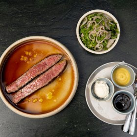 Wagyu flank with condiments and salad.