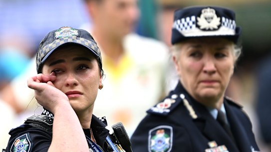 Constable Bree Trost (left) and Commissioner Katarina Carroll at the Gabba on Saturday during a moving tribute to colleagues Rachel McCrow and Matthew Arnold, and Good Samaritan neighbour Alan Dare.