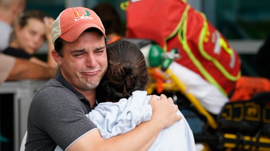 A couple embrace as they wait for news of survivors from the collapse. 