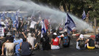 Israeli police use water cannon to disperse demonstrators blocking the road leading to the Knesset, Israel’s parliament.