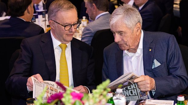 Kerry Stokes shows a copy of The West Australian to Anthony Albanese in 2022.