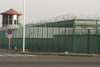 A guard tower and barbed wire fences are seen around a facility in the Kunshan Industrial Park in Artux in western China's Xinjiang region. People in touch with state employees in China say the government in the far west region of Xinjiang is destroying documents and taking other steps to tighten control on information. 