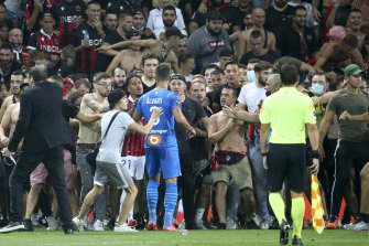 Marseille’s Alvaro Gonzalez confronts Nice supporters.