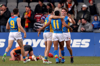 Suns players embrace after the final siren.